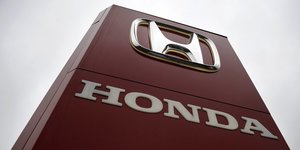 A honda sign is seen outside a dealership in ottershaw, southern england